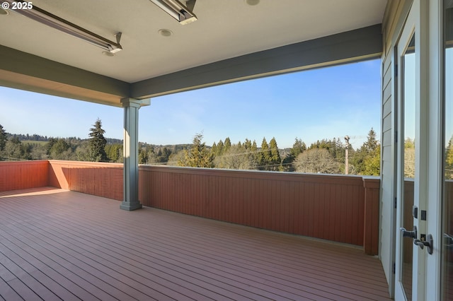 wooden terrace featuring a forest view