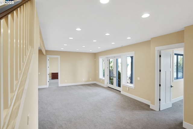 carpeted spare room with baseboards, french doors, and recessed lighting