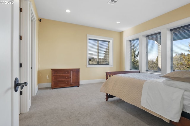 bedroom featuring recessed lighting, light colored carpet, visible vents, and baseboards