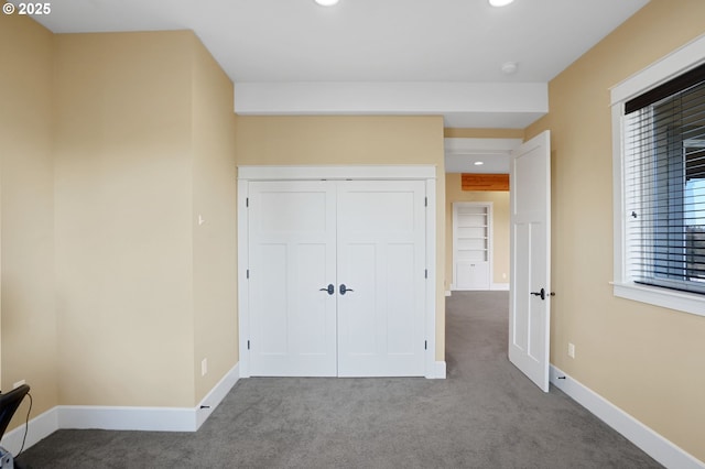 unfurnished bedroom with carpet floors, baseboards, a closet, and recessed lighting