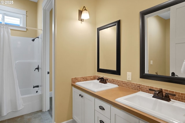 bathroom with shower / bathtub combination with curtain, a sink, and backsplash