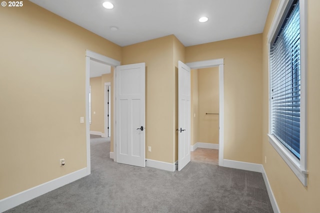 unfurnished bedroom with recessed lighting, carpet flooring, and baseboards