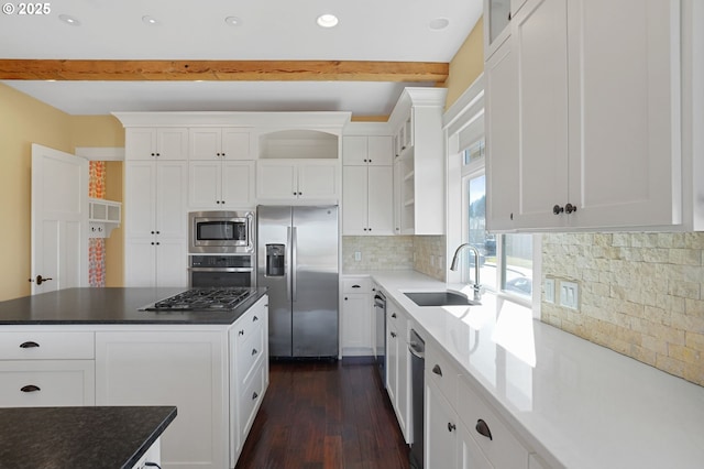 kitchen with open shelves, appliances with stainless steel finishes, a sink, and white cabinetry