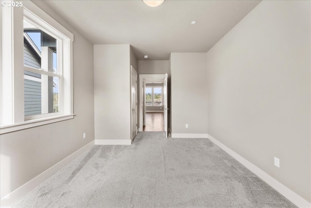 spare room featuring baseboards and carpet flooring