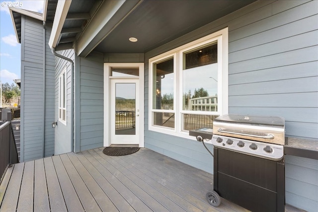 wooden terrace featuring a grill