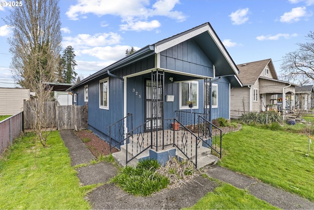 bungalow with a front yard and fence