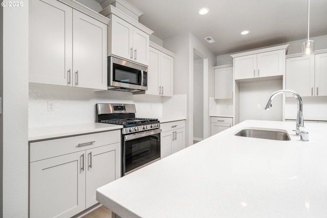 8900 S 1st St Unit 17, Ridgefield, WA 98642 - kitchen with appliances with stainless steel finishes, light countertops, recessed lighting, hanging light fixtures, and white cabinetry