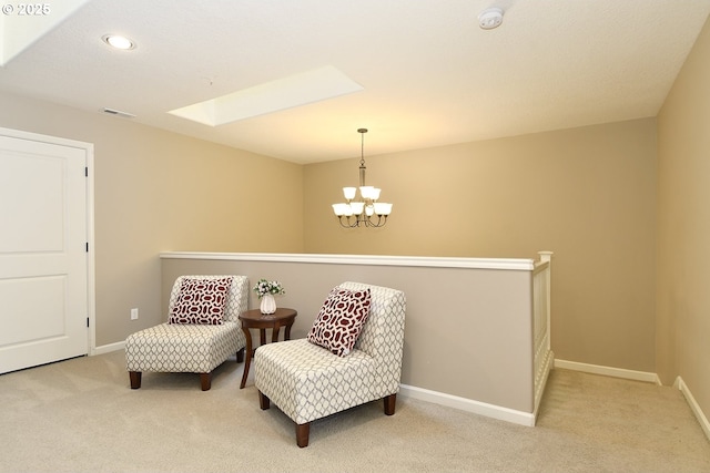 sitting room with a skylight, light carpet, and a notable chandelier