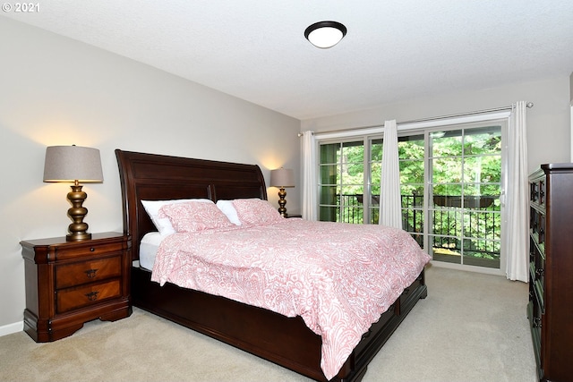 carpeted bedroom featuring access to outside and a textured ceiling