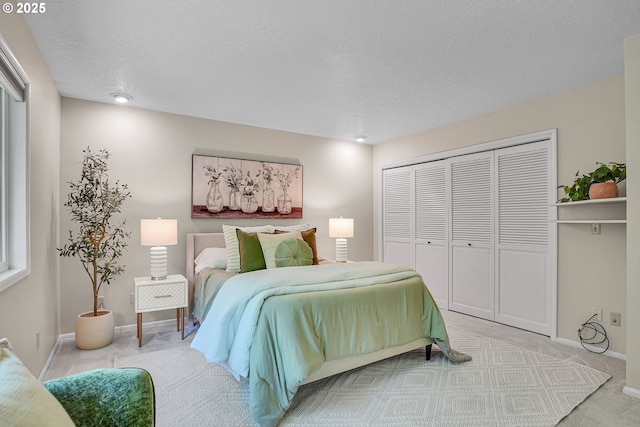 carpeted bedroom featuring a closet, baseboards, and a textured ceiling