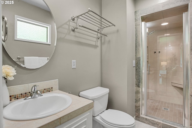 full bath featuring a stall shower, toilet, vanity, and backsplash