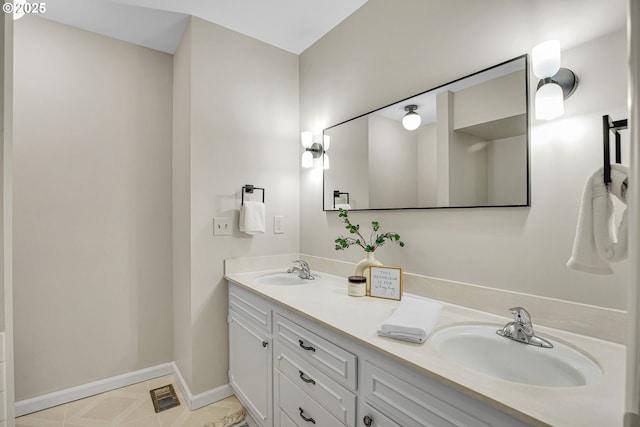 full bathroom featuring double vanity and baseboards