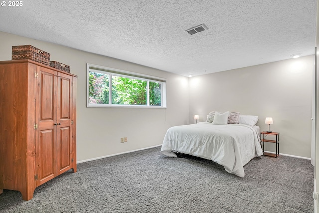 bedroom featuring a textured ceiling, carpet floors, and baseboards