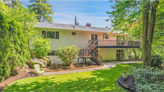 back of property with a wooden deck, stairway, a yard, a chimney, and roof with shingles