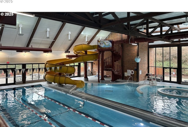 indoor community pool featuring a water slide