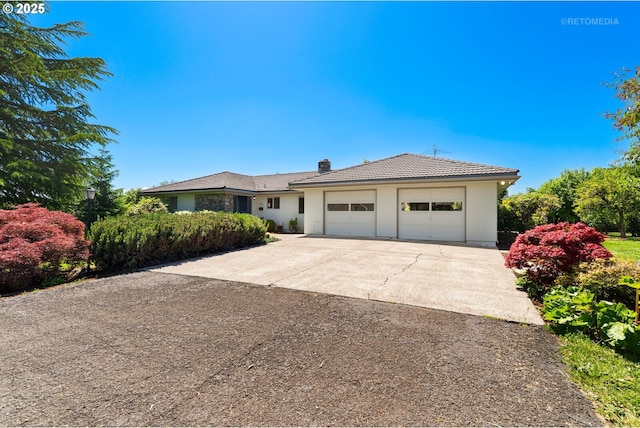 1810 D St, Forest Grove, OR 97116 - ranch-style house with a chimney, an attached garage, driveway, and a tiled roof
