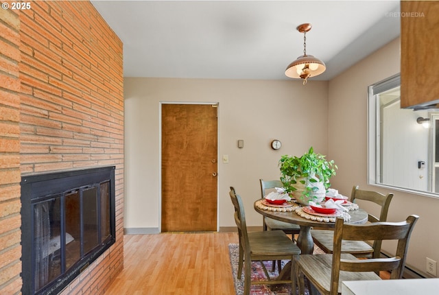 1810 D St, Forest Grove, OR 97116 - dining area featuring a large fireplace, light wood-style flooring, and baseboards