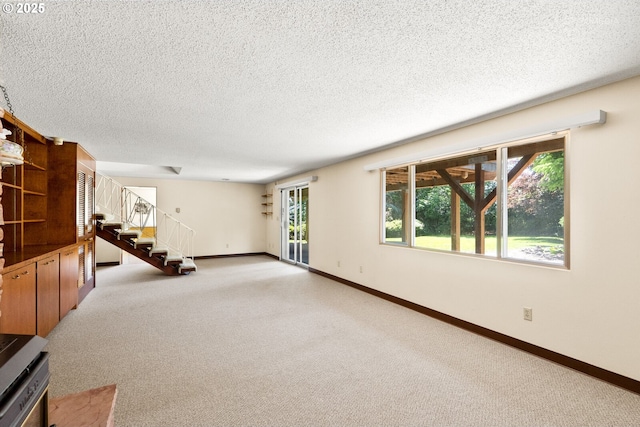 1810 D St, Forest Grove, OR 97116 - unfurnished living room with stairs, light carpet, plenty of natural light, and a textured ceiling