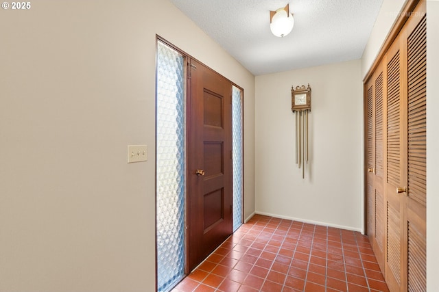 1810 D St, Forest Grove, OR 97116 - entrance foyer featuring a textured ceiling, tile patterned floors, and baseboards
