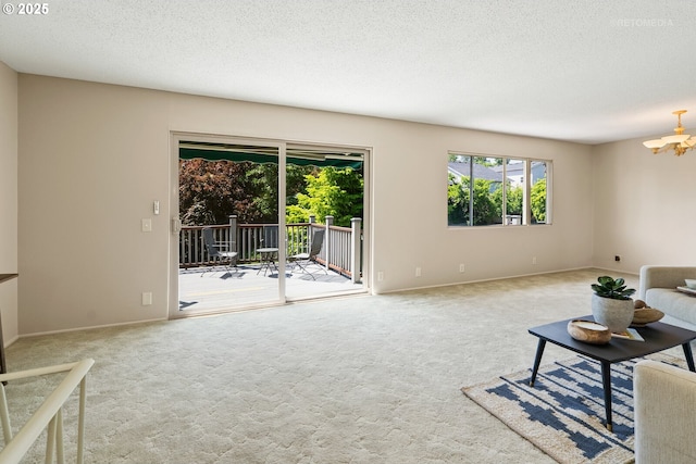 1810 D St, Forest Grove, OR 97116 - unfurnished living room with carpet, a chandelier, baseboards, and a textured ceiling