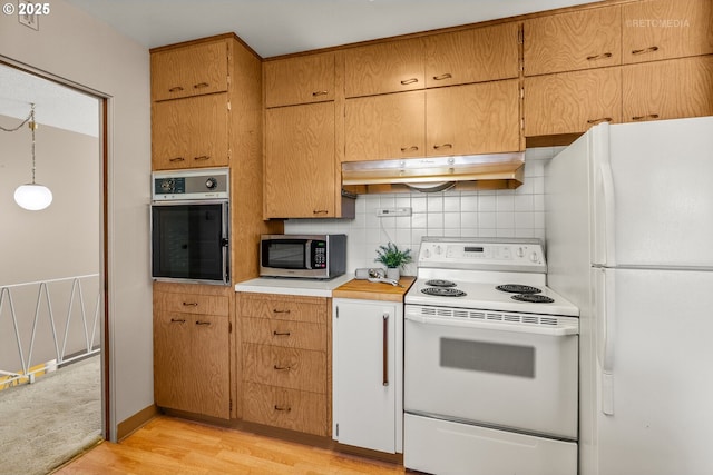 1810 D St, Forest Grove, OR 97116 - kitchen featuring stainless steel appliances, under cabinet range hood, light wood finished floors, tasteful backsplash, and light countertops