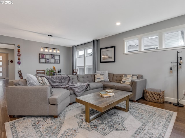 living room with recessed lighting, baseboards, and wood finished floors