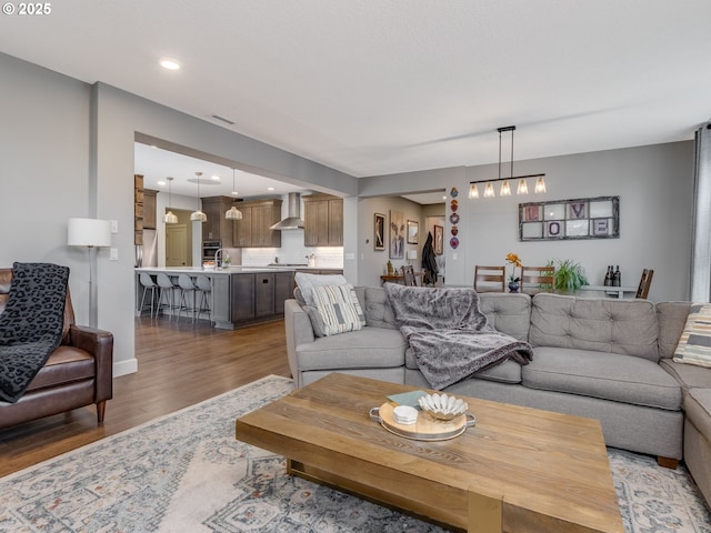 living area featuring visible vents and light wood-style flooring