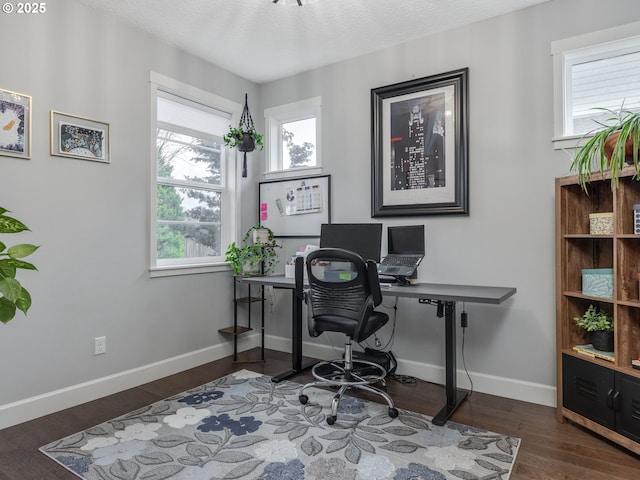 office space featuring wood finished floors, baseboards, and a textured ceiling