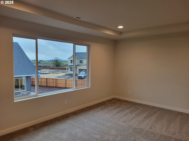 carpeted spare room featuring visible vents, baseboards, and recessed lighting