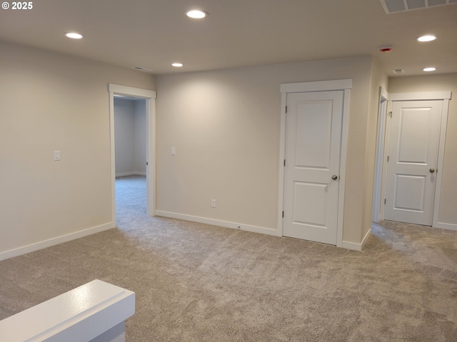 empty room with carpet floors, baseboards, and recessed lighting