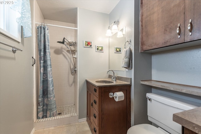 full bath with vanity, baseboards, tile patterned flooring, a shower stall, and toilet