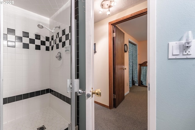 bathroom with baseboards and a stall shower