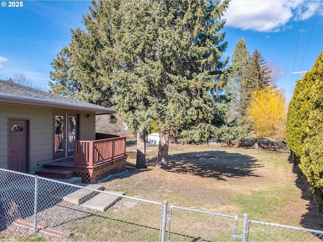 view of yard featuring a fenced front yard and a deck