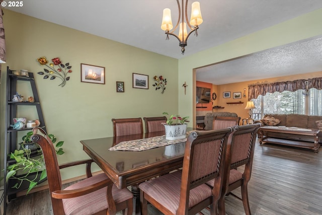 dining room with a chandelier and wood finished floors