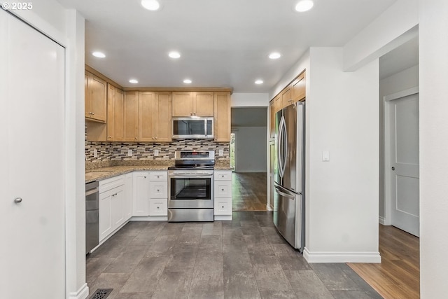 6841 SW Sussex St, Beaverton, OR 97008 - kitchen with stainless steel appliances, dark wood finished floors, light stone countertops, tasteful backsplash, and recessed lighting
