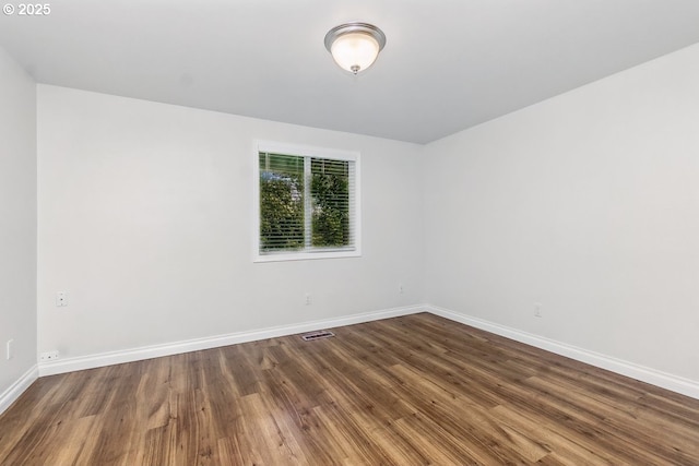 6841 SW Sussex St, Beaverton, OR 97008 - unfurnished room featuring dark wood-style flooring and baseboards