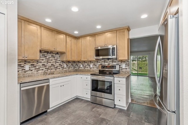 6841 SW Sussex St, Beaverton, OR 97008 - kitchen featuring stainless steel appliances, a sink, decorative backsplash, light brown cabinetry, and light stone counters
