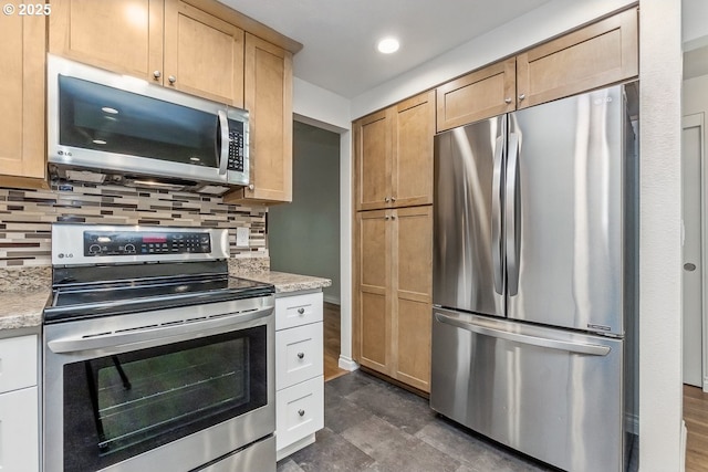 6841 SW Sussex St, Beaverton, OR 97008 - kitchen with appliances with stainless steel finishes, backsplash, recessed lighting, and light stone countertops