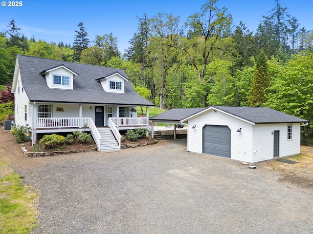 new england style home featuring an outdoor structure, central AC, stairway, covered porch, and driveway