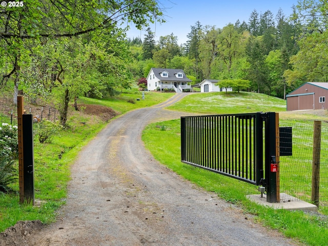 view of road featuring a gated entry and driveway