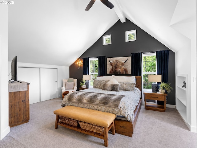 bedroom featuring vaulted ceiling with beams, a ceiling fan, a closet, and light colored carpet
