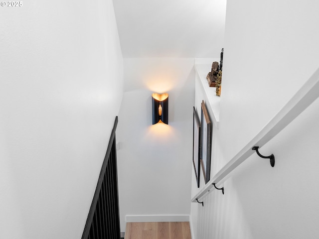 stairs with baseboards and wood finished floors