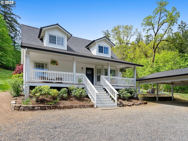cape cod house with covered porch, driveway, stairs, and roof with shingles