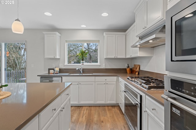 kitchen featuring sink, white cabinets, and a healthy amount of sunlight