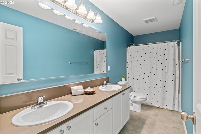 bathroom featuring toilet, vanity, and a shower with curtain