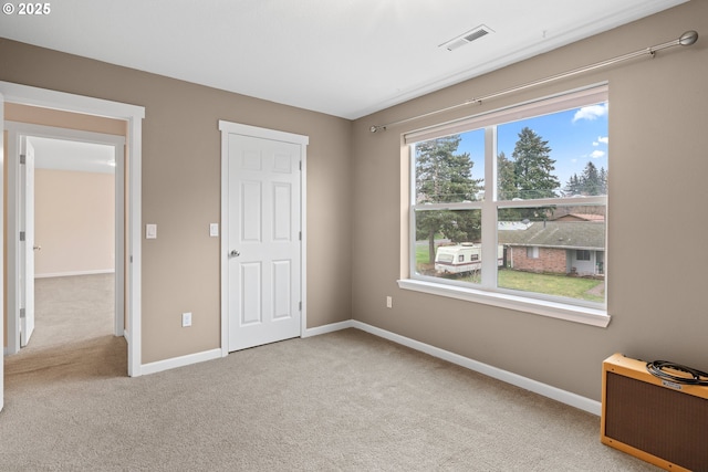 unfurnished bedroom featuring light colored carpet and radiator