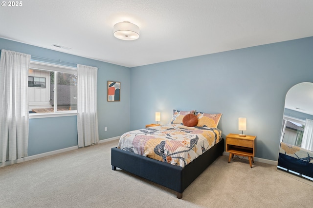 bedroom featuring light colored carpet