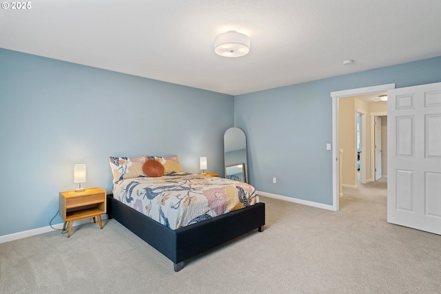 bedroom featuring light carpet