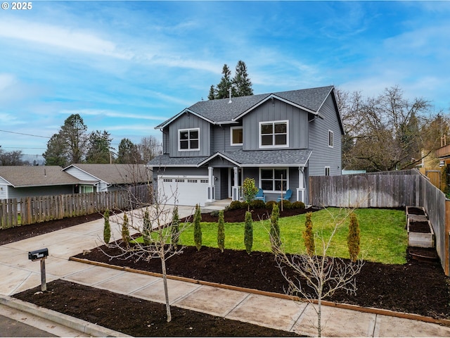 view of front of home featuring a front yard and a garage