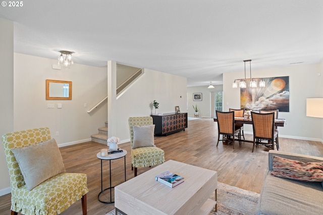 living room with a notable chandelier and hardwood / wood-style floors